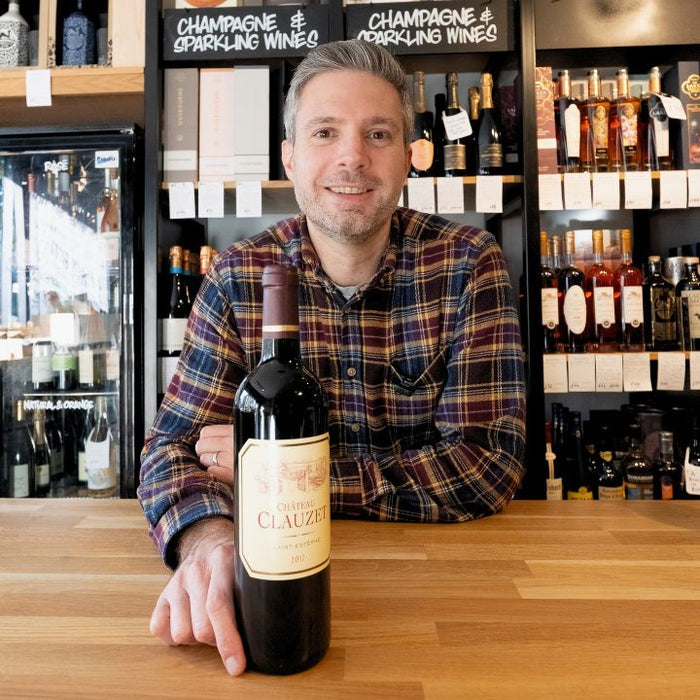 NIc holding a bottle of Chateau Clauzet in a Reserve Wines Didsbury store