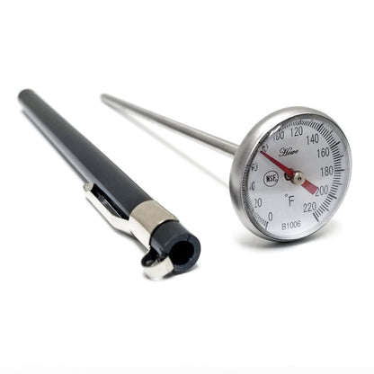 Temperature dial at the top of steel bar. Black case for thermometer sitting next to it.
