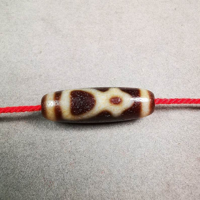 Kubera Dzi Bead - Tibetan dzi bead, front view