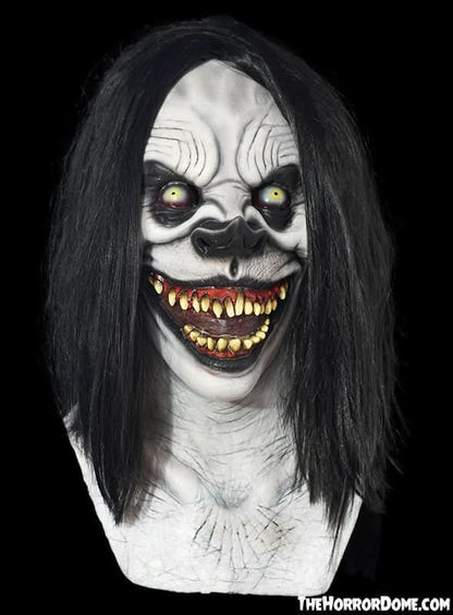 Squeaks the Clown Halloween mask by The Horror Dome. Hand-painted, haired silicone clown disguise with chilling grin, rotting teeth, fiery hair. Hyper-realistic original design. Perfect for terrifying coulrophobics or starring in indie horror films. Features premium silicone construction and seamless over-head fit.