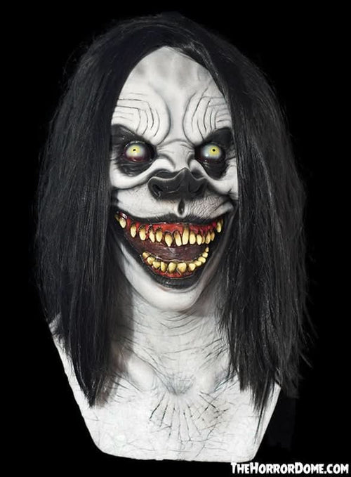 Squeaks the Clown Halloween mask by The Horror Dome. Hand-painted, haired silicone clown disguise with chilling grin, rotting teeth, fiery hair. Hyper-realistic original design. Perfect for terrifying coulrophobics or starring in indie horror films. Features premium silicone construction and seamless over-head fit.