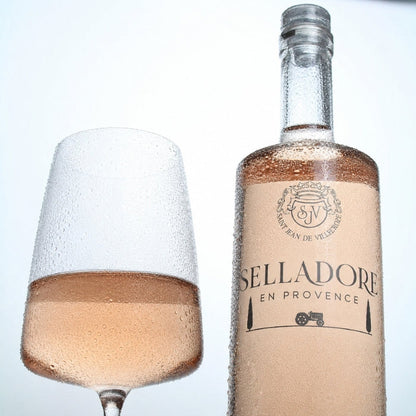 Selladore en provence rose with glass of rose - cold with condensation on a white background